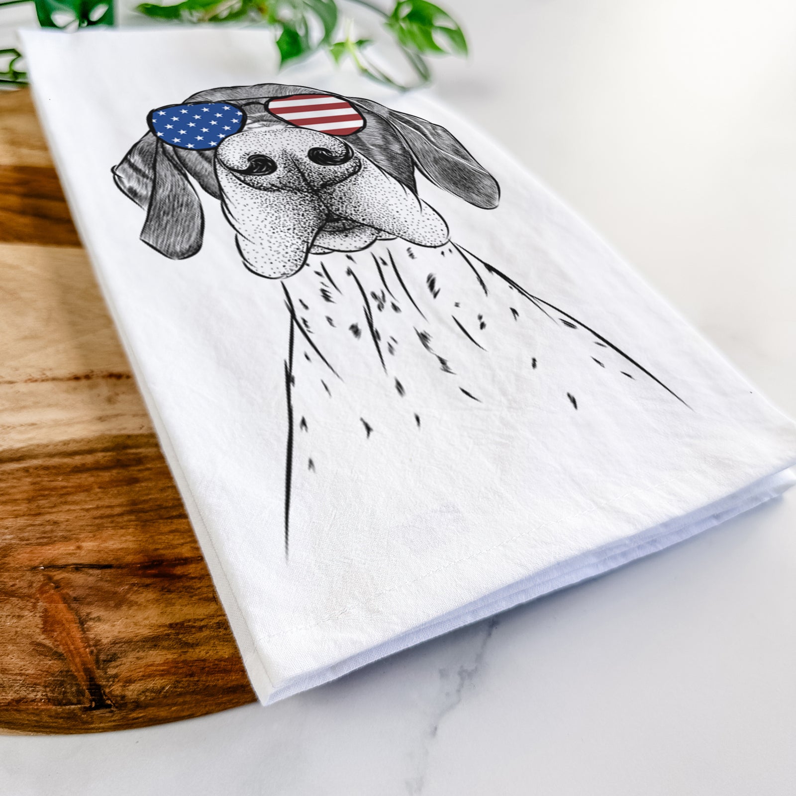 Hand-drawn sketch of Booze the German Shorthaired Pointer wearing American flag sunglasses on a tea towel