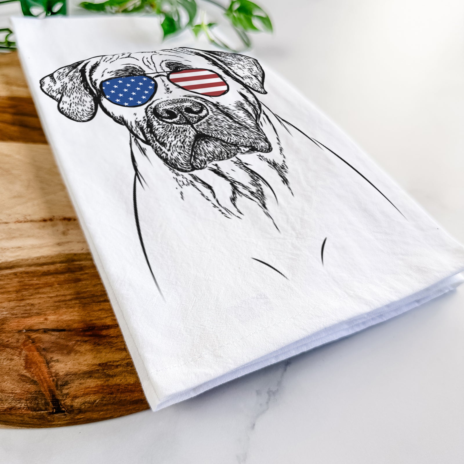 Hand-drawn sketch of Boris the Boerboel wearing American flag sunglasses on a tea towel