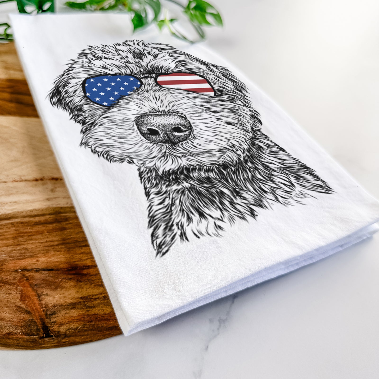 Hand-drawn sketch of Bowser the Whoodle wearing American flag sunglasses on a tea towel
