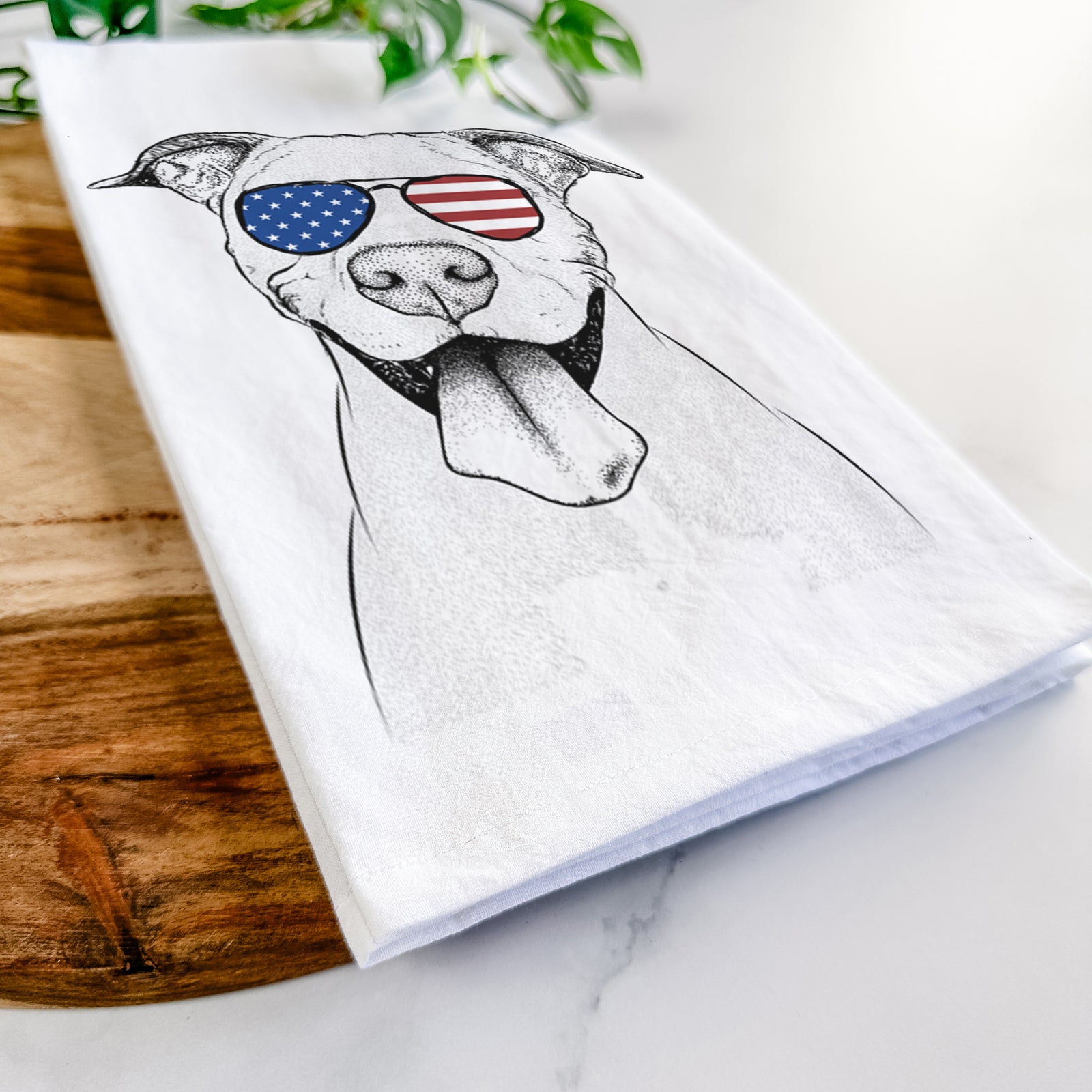 Hand-drawn sketch of Bruce the American Staffordshire Terrier wearing American flag sunglasses on a tea towel