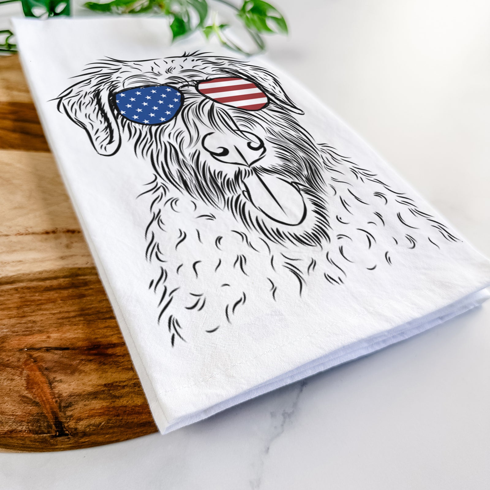 Hand-drawn sketch of Chester the Soft Coated Wheaten Terrier wearing American flag sunglasses on a tea towel