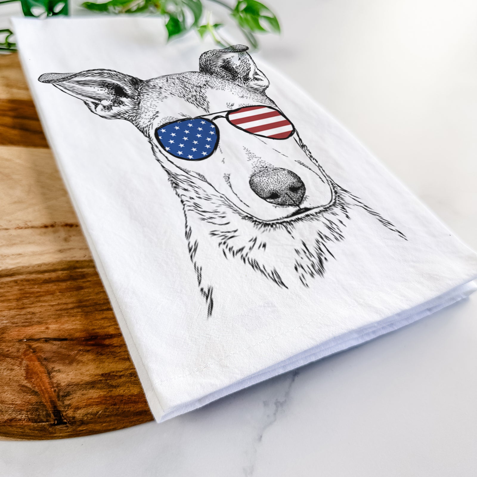 Hand-drawn sketch of Coral the Mixed Breed wearing American flag sunglasses on a tea towel