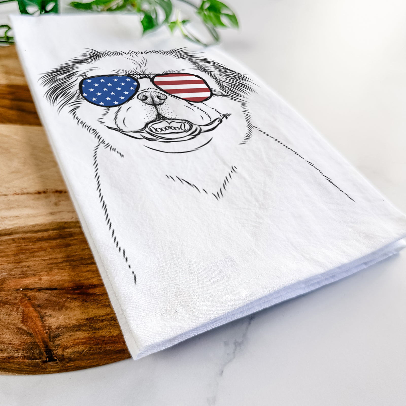 Hand-drawn sketch of Danny the Pekingese wearing American flag sunglasses on a tea towel