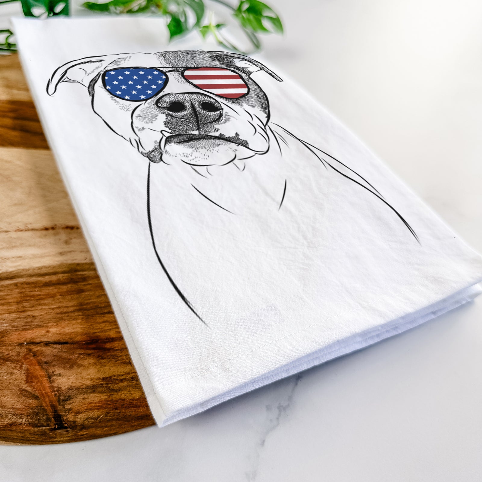 Hand-drawn sketch of Dexter the Pitbull wearing American flag sunglasses on a tea towel