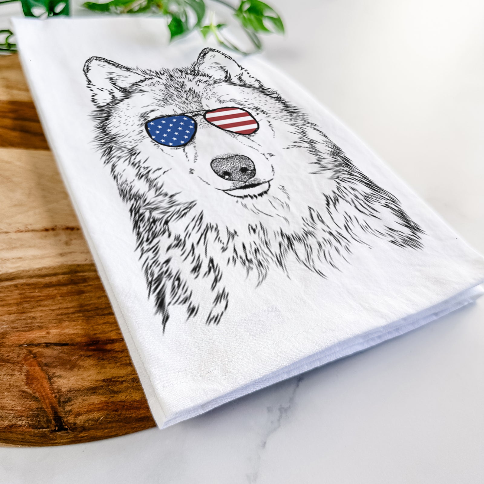 Hand-drawn sketch of Django the Grey Wolf wearing American flag sunglasses on a tea towel