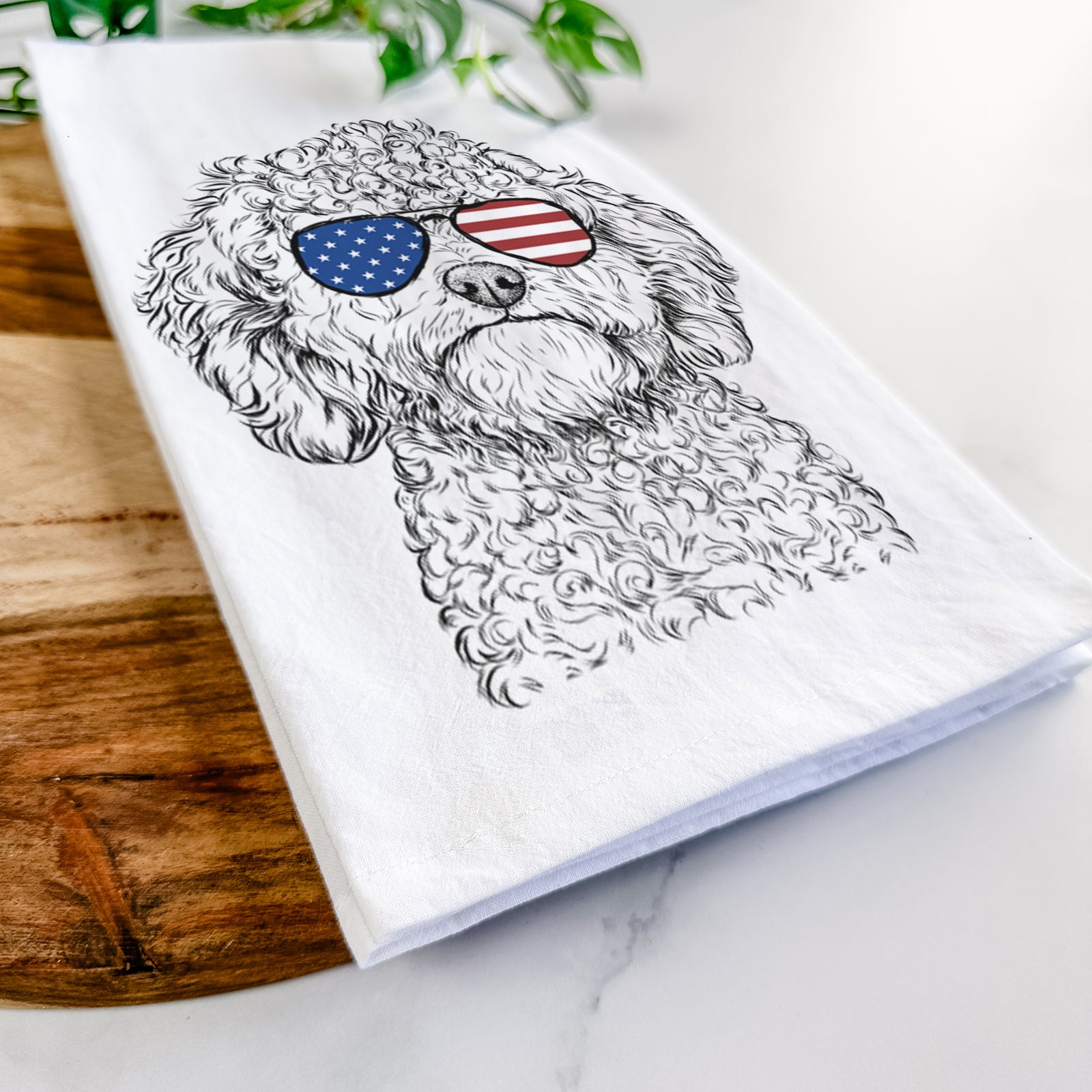 Hand-drawn sketch of Edgar the Shihpoo wearing American flag sunglasses on a tea towel