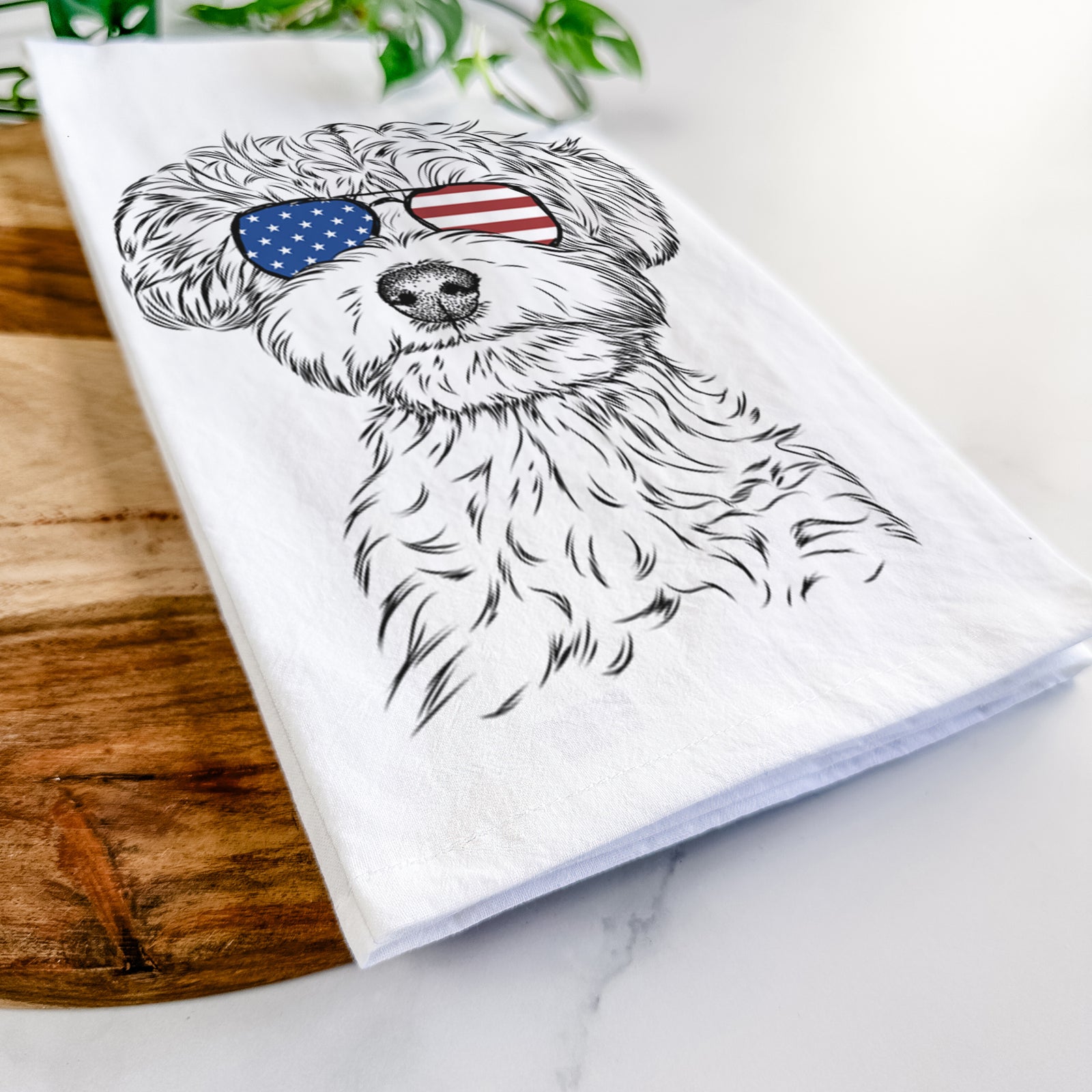 Hand-drawn sketch of Elliott the Yorkiepoo wearing American flag sunglasses on a tea towel