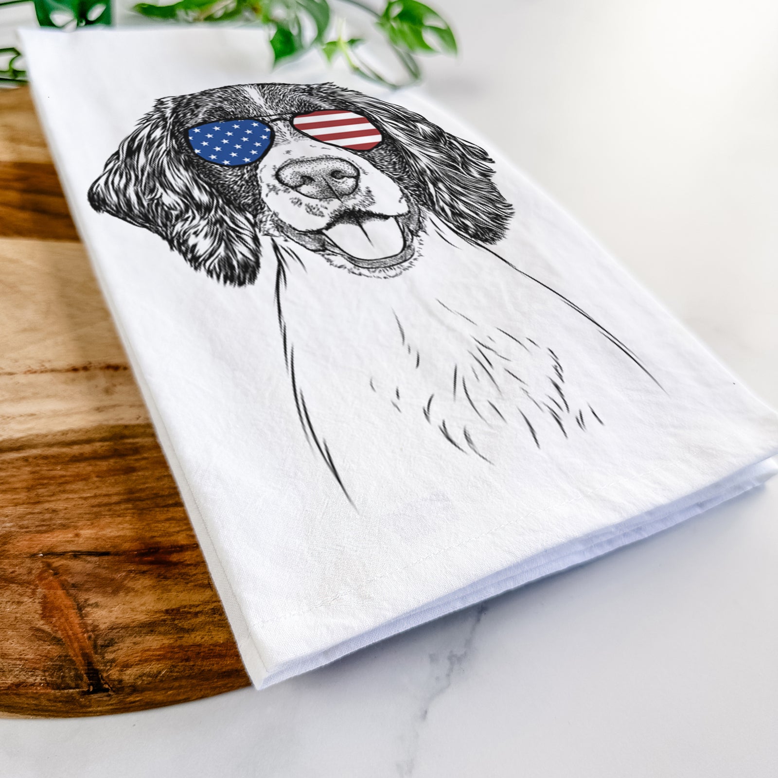 Hand-drawn sketch of Ever the English Springer Spaniel wearing American flag sunglasses on a tea towel