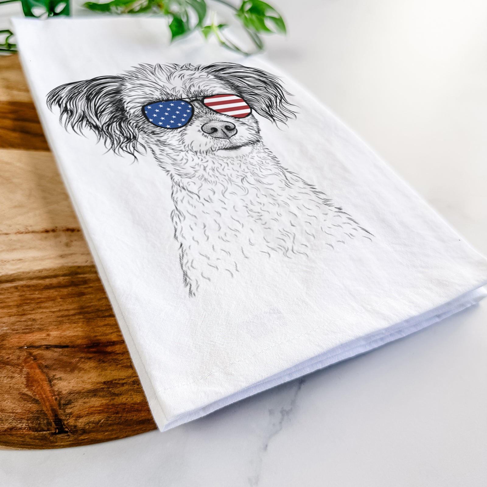 Hand-drawn sketch of Finley the Papillon Mix wearing American flag sunglasses on a tea towel