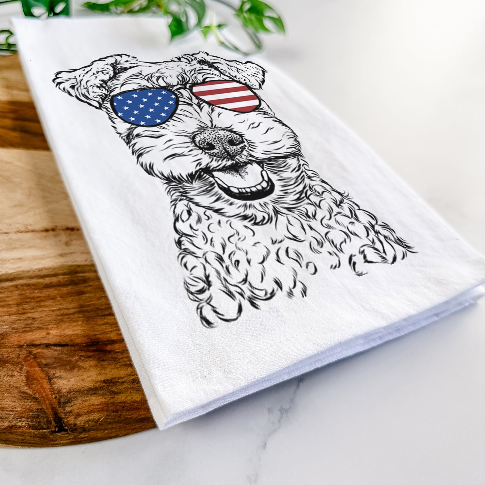 Hand-drawn sketch of Fintan the Irish Troodle wearing American flag sunglasses on a tea towel