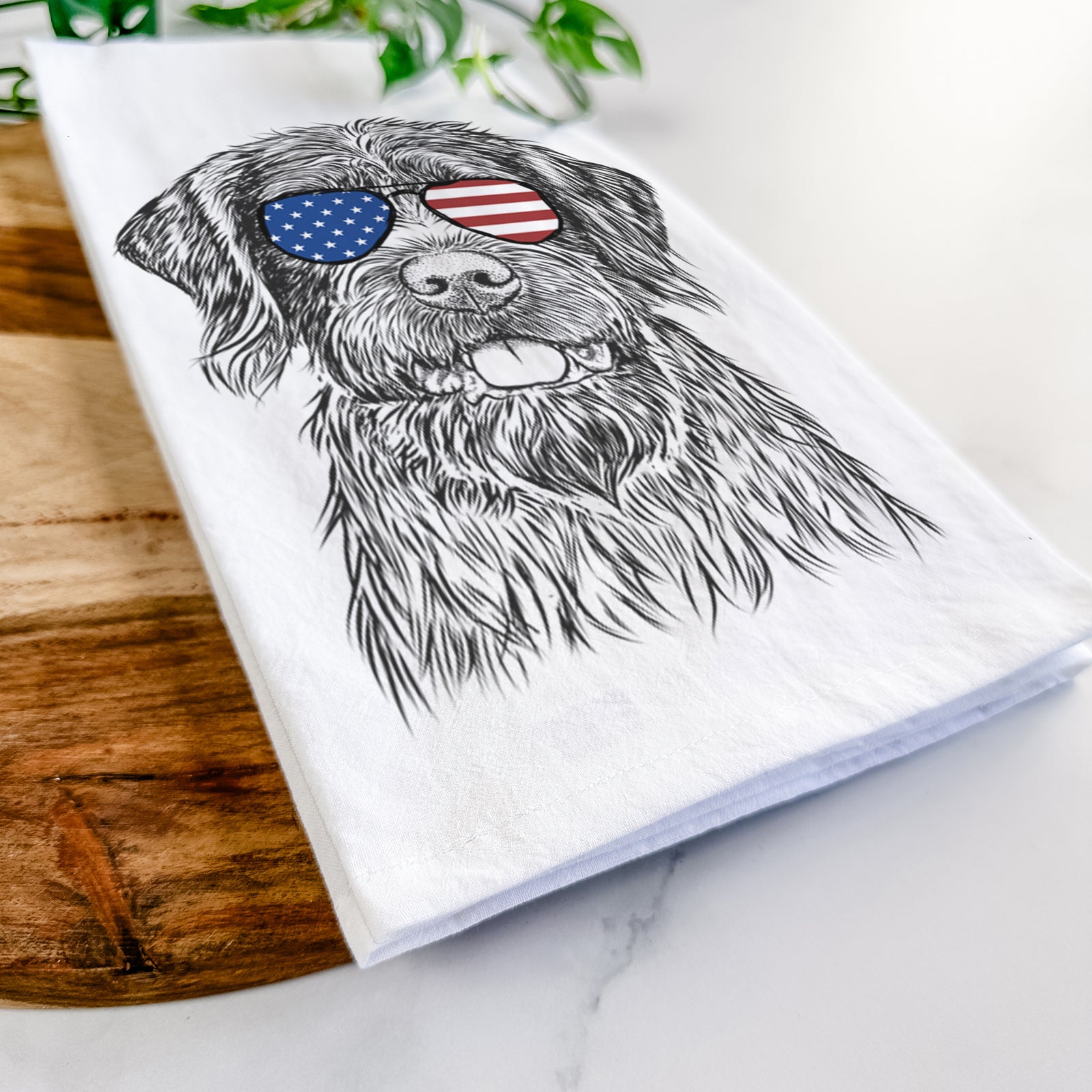Hand-drawn sketch of Fletcher the Wirehaired Pointing Griffon wearing American flag sunglasses on a tea towel