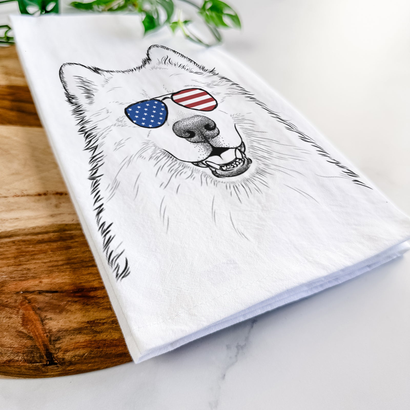 Hand-drawn sketch of Foster the Samoyed wearing American flag sunglasses on a tea towel