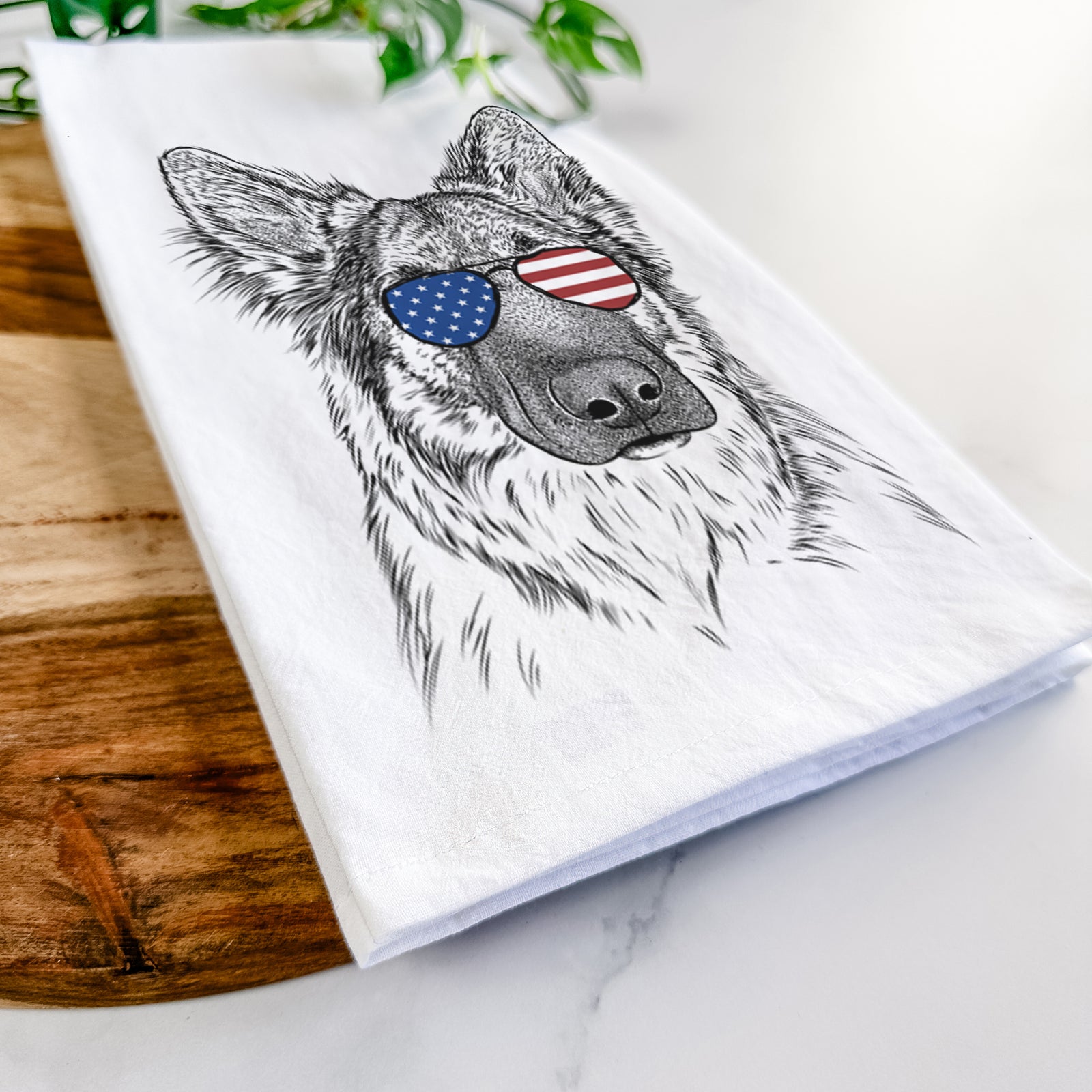Hand-drawn sketch of Geddy the Shiloh Shepherd wearing American flag sunglasses on a tea towel