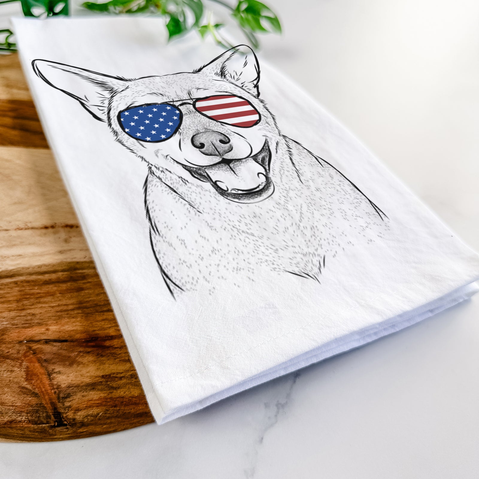 Hand-drawn sketch of Georgie the Chiweenie wearing American flag sunglasses on a tea towel