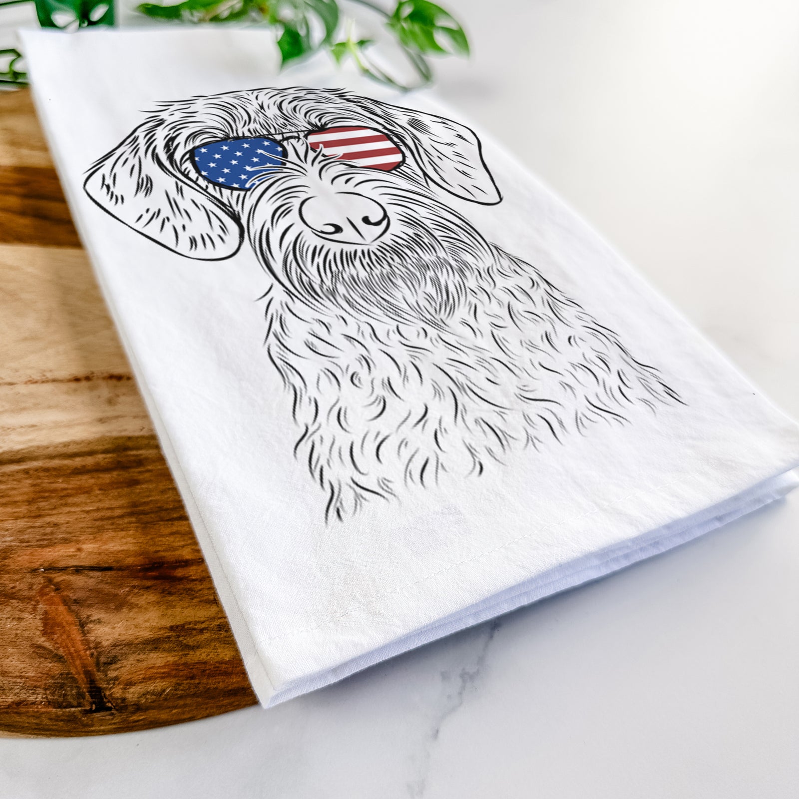 Hand-drawn sketch of Gus the German Wirehaired Pointer wearing American flag sunglasses on a tea towel