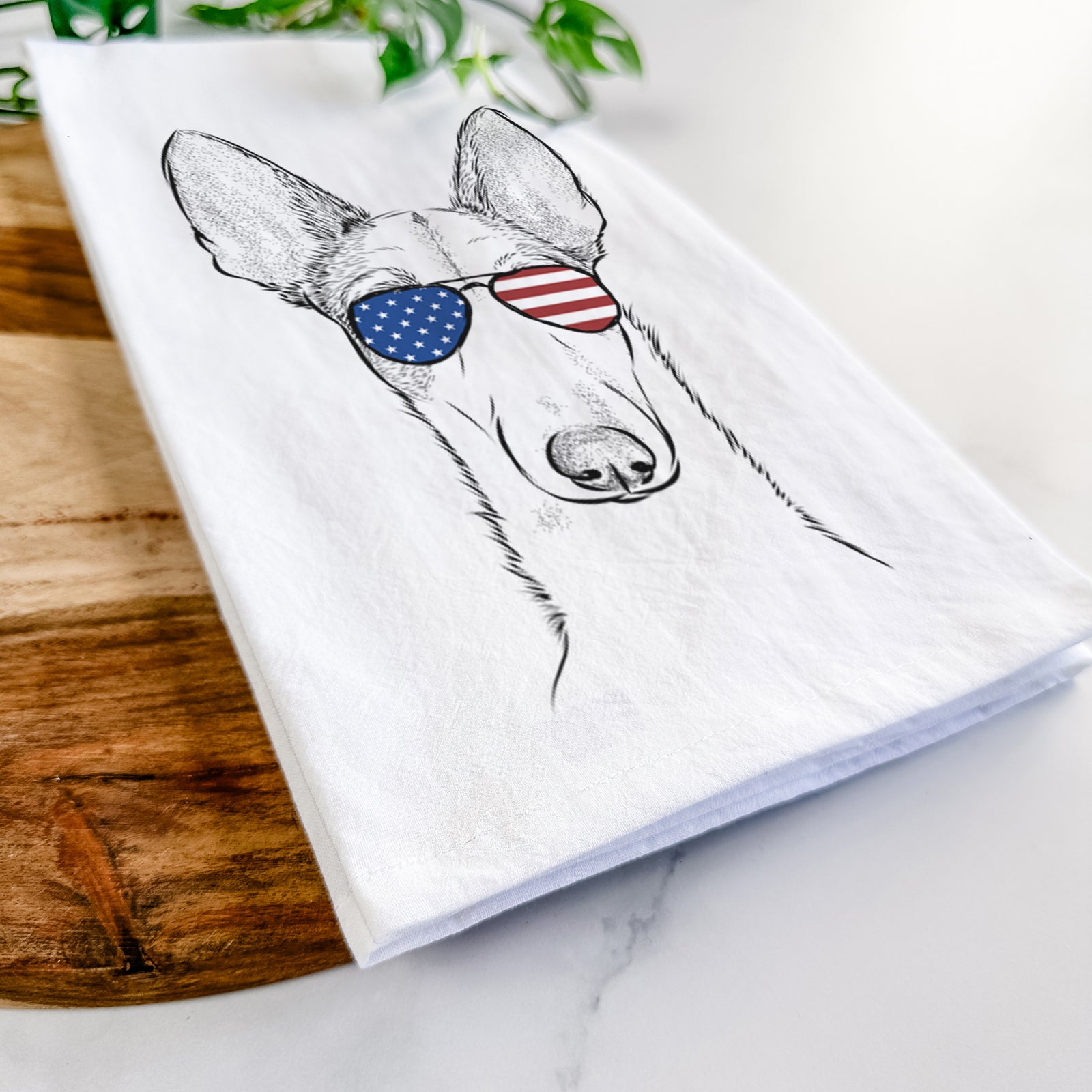 Hand-drawn sketch of Halo the Ibizan Sight Hound wearing American flag sunglasses on a tea towel