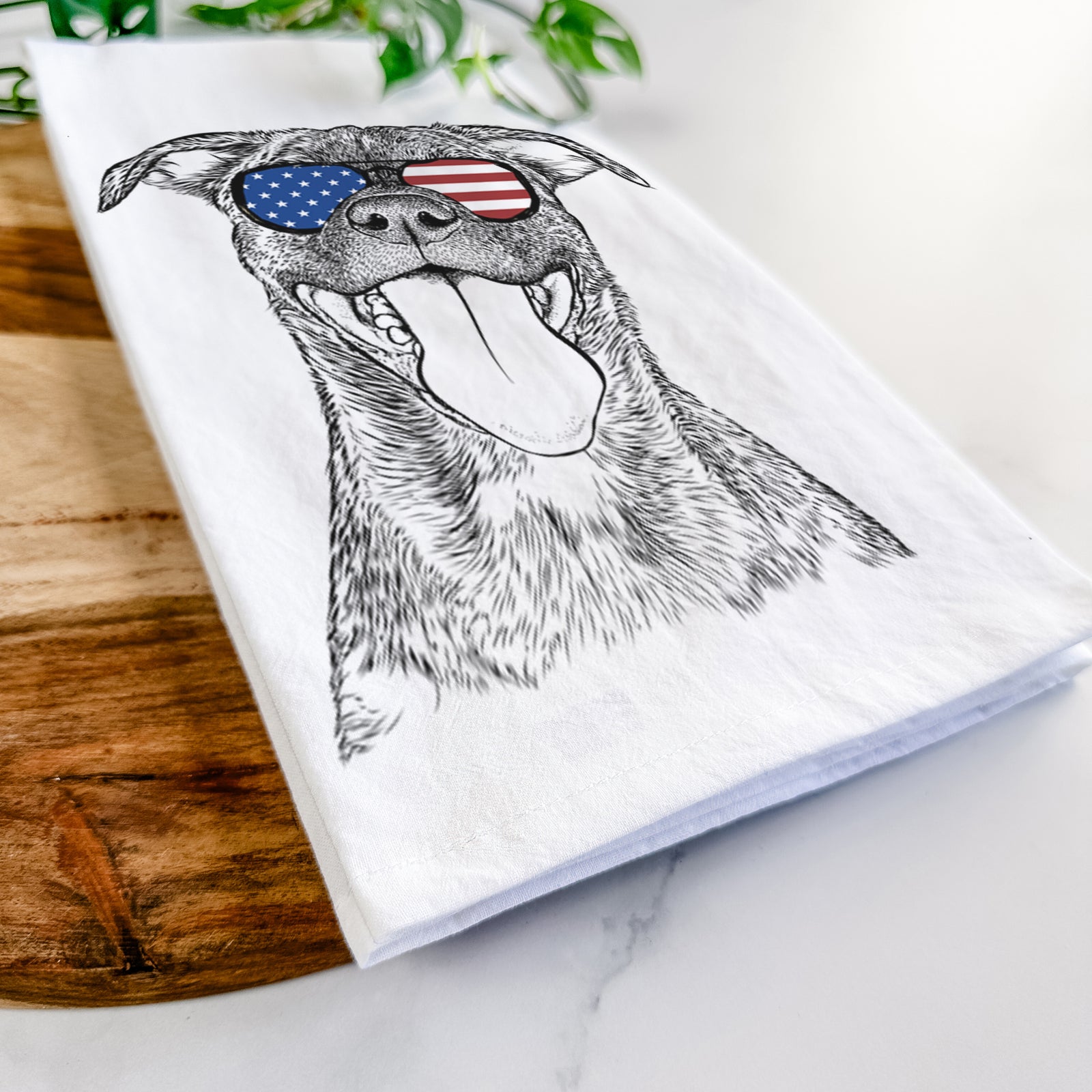 Hand-drawn sketch of Harley the Pitbull Mix wearing American flag sunglasses on a tea towel