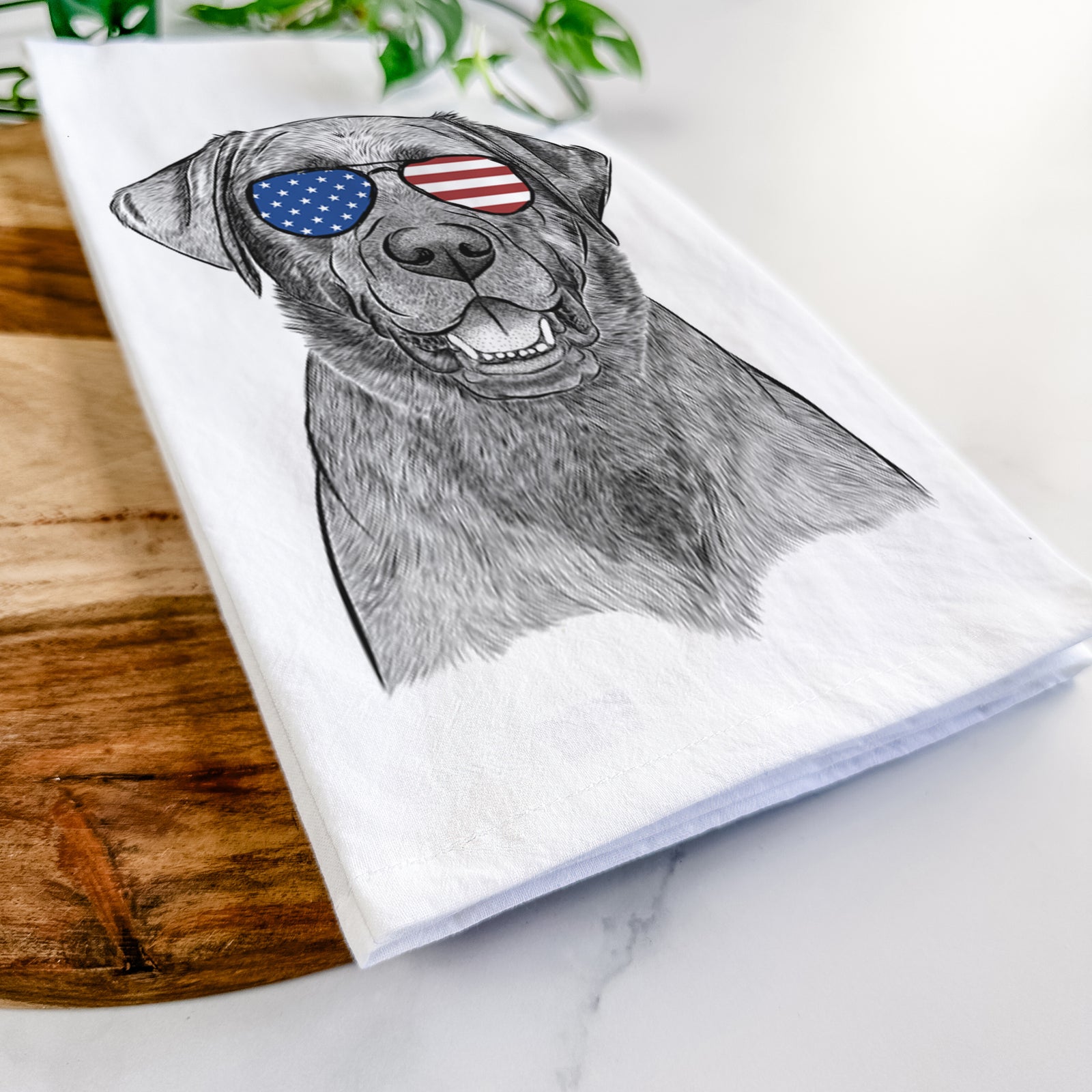 Hand-drawn sketch of Heath the Black Lab wearing American flag sunglasses on a tea towel