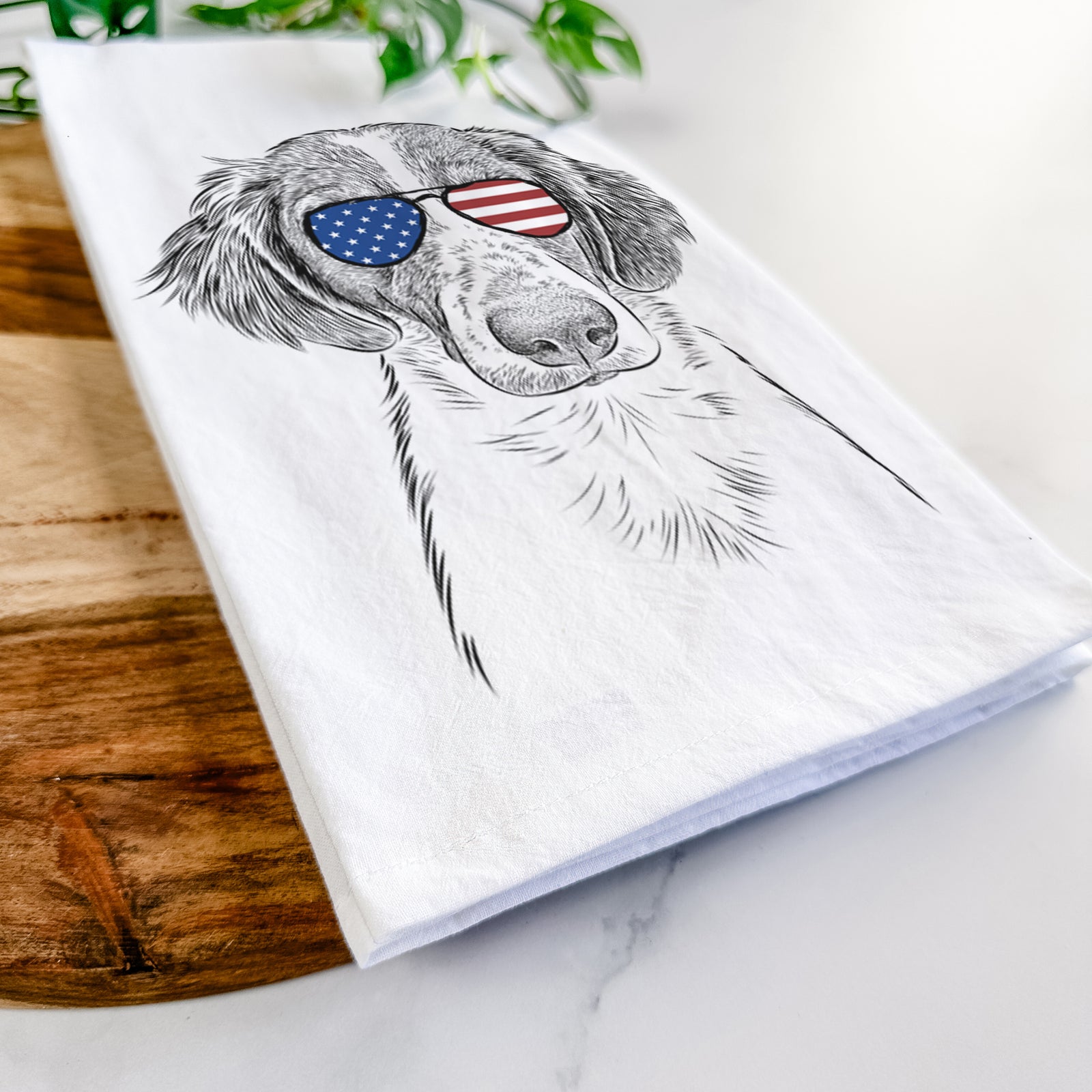 Hand-drawn sketch of Holly the Brittany Spaniel wearing American flag sunglasses on a tea towel