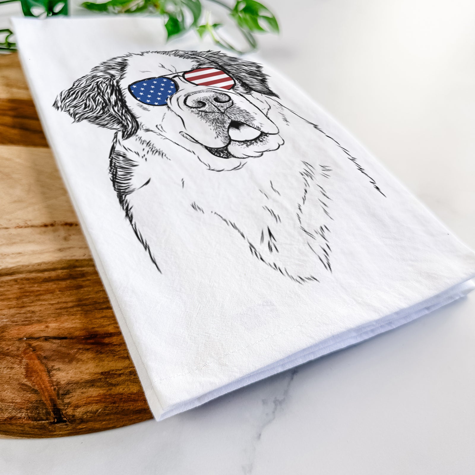 Hand-drawn sketch of Hook the Saint Bernard wearing American flag sunglasses on a tea towel