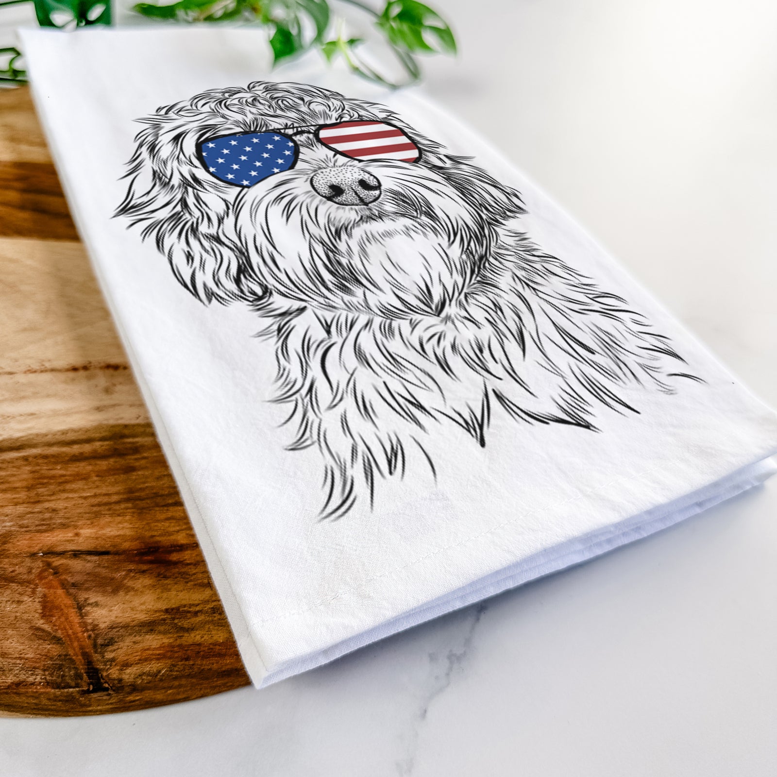 Hand-drawn sketch of Huckleberry the Australian Labradoodle wearing American flag sunglasses on a tea towel