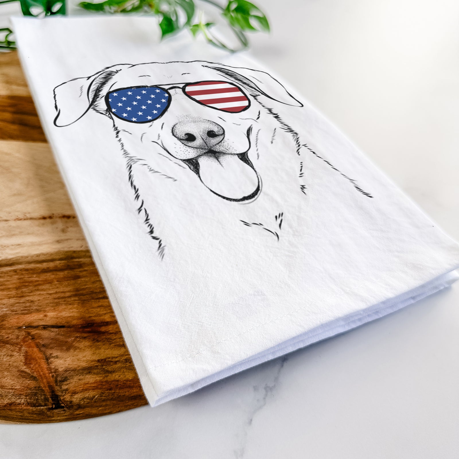 Hand-drawn sketch of Hudson the Shepherd wearing American flag sunglasses on a tea towel