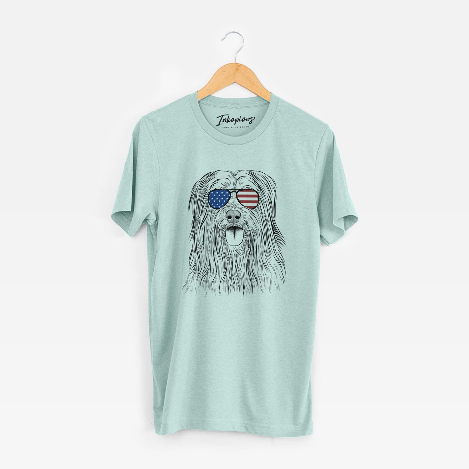 Hand-drawn sketch of Indy the Korean Sapsali wearing American flag sunglasses on a Heather Sage Unisex crewneck
