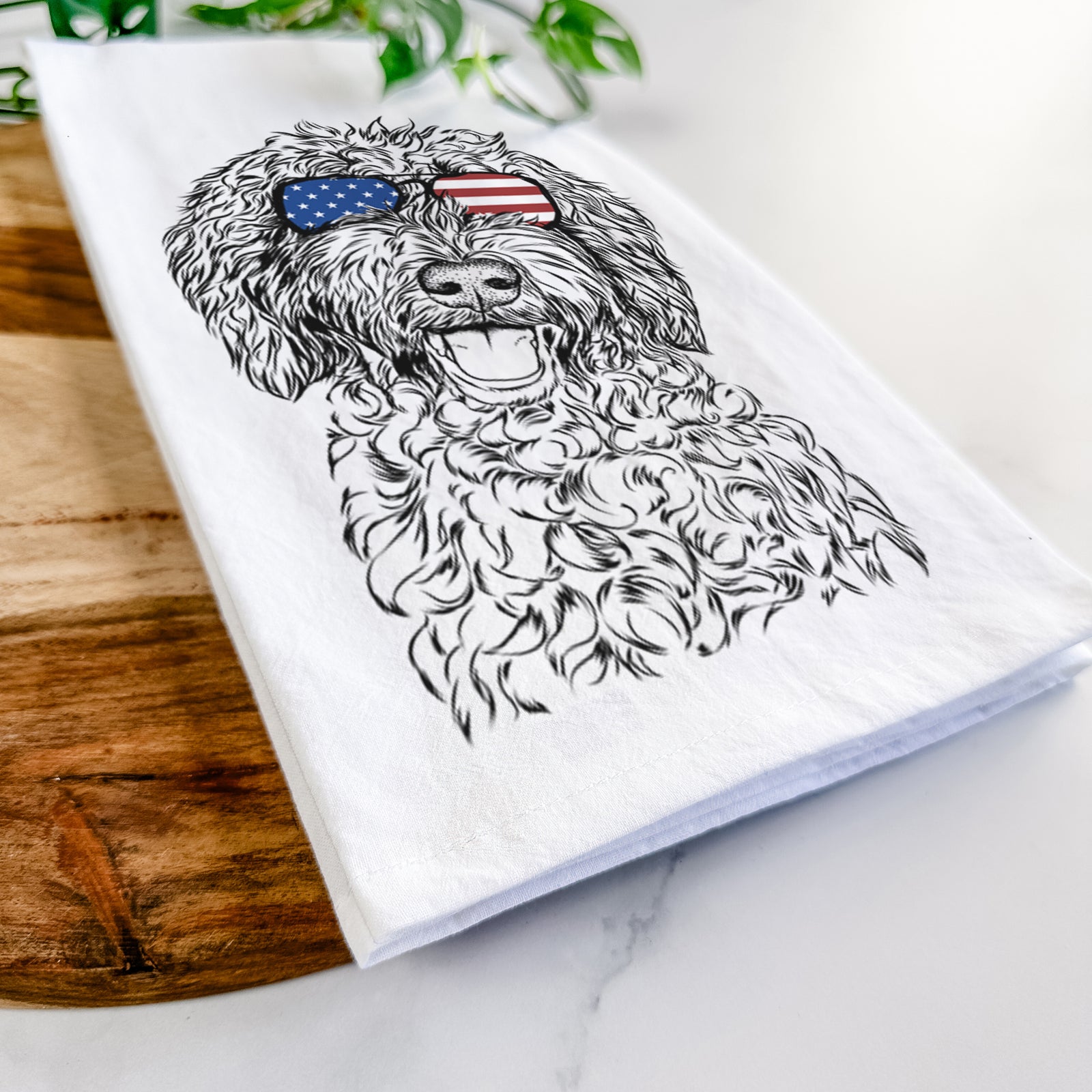 Hand-drawn sketch of Jack the Chocolate Labradoodle wearing American flag sunglasses on a tea towel