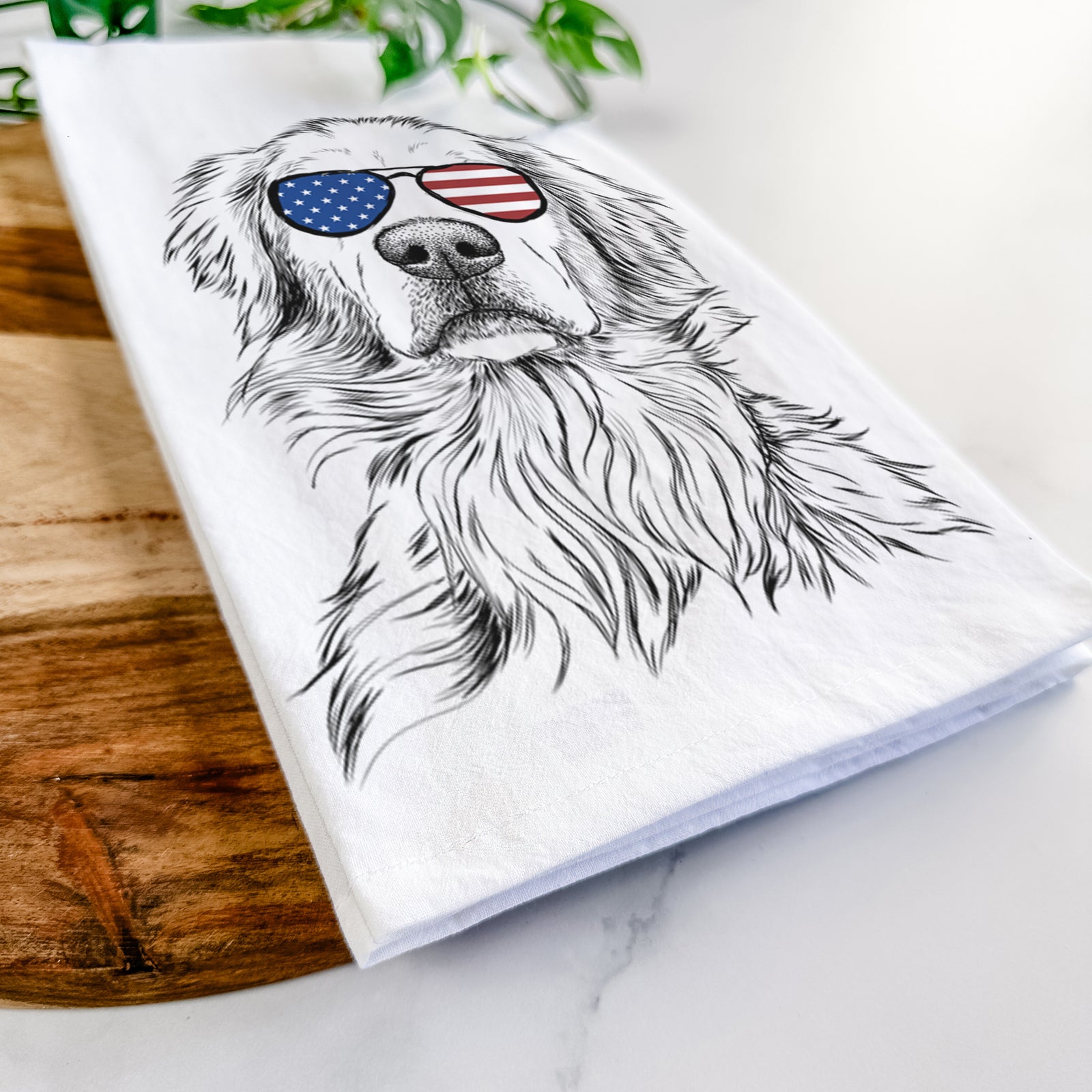 Hand-drawn sketch of Jake aroni the Golden Retriever wearing American flag sunglasses on a tea towel