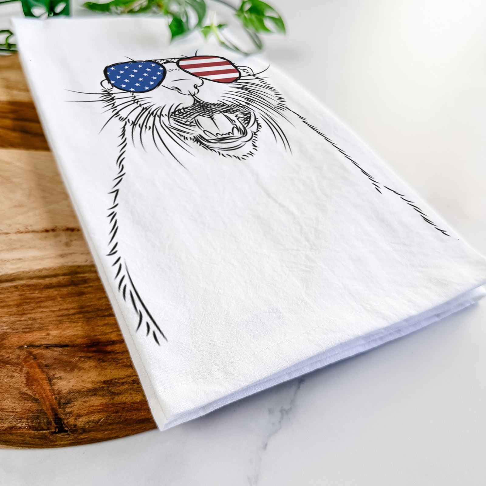 Hand-drawn sketch of Jasper the River Otter wearing American flag sunglasses on a tea towel