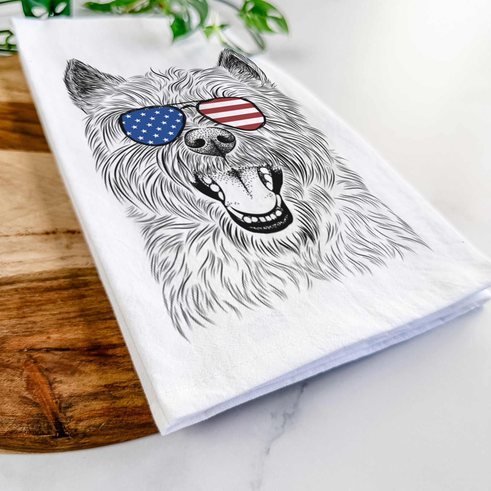Hand-drawn sketch of Jeff the Cairn Terrier wearing American flag sunglasses on a tea towel