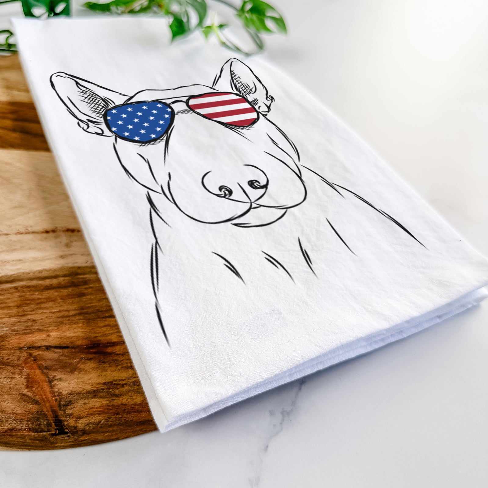 Hand-drawn sketch of Jett the Bull Terrier wearing American flag sunglasses on a tea towel