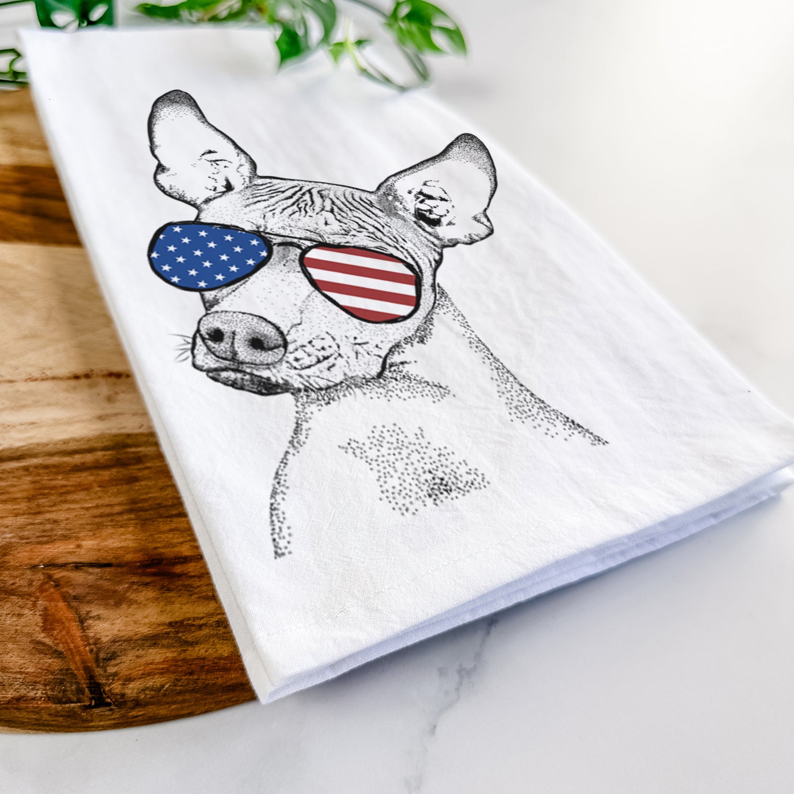 Hand-drawn sketch of Kahlo the Xoloitzcuintli wearing American flag sunglasses on a tea towel