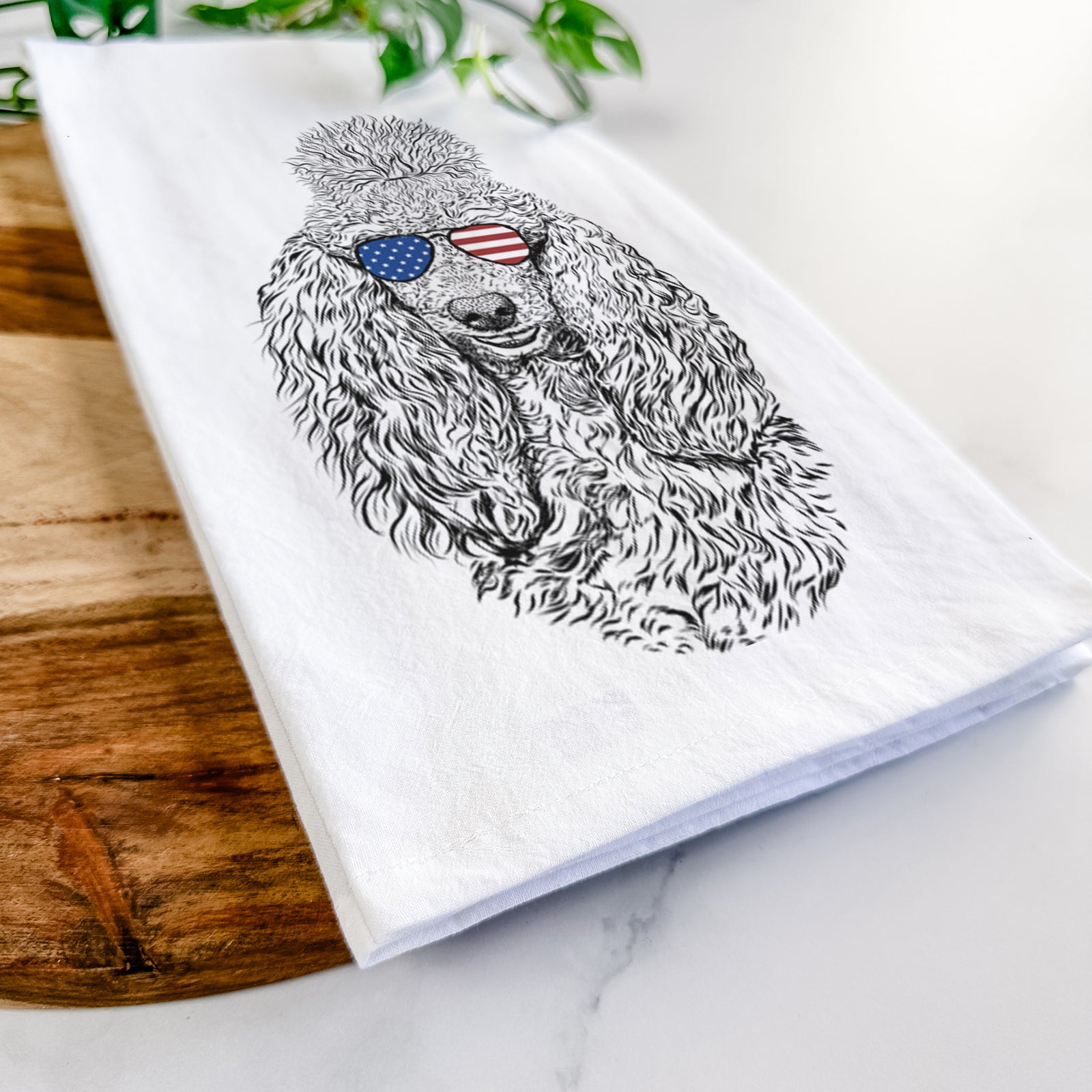 Hand-drawn sketch of Kenna the Standard Poodle wearing American flag sunglasses on a tea towel