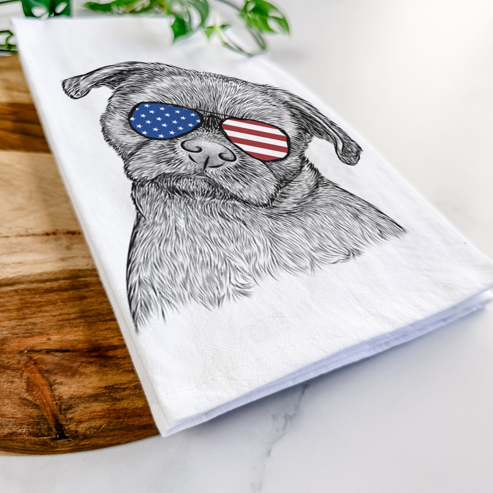 Hand-drawn sketch of Koko the Shih Tzu wearing American flag sunglasses on a tea towel