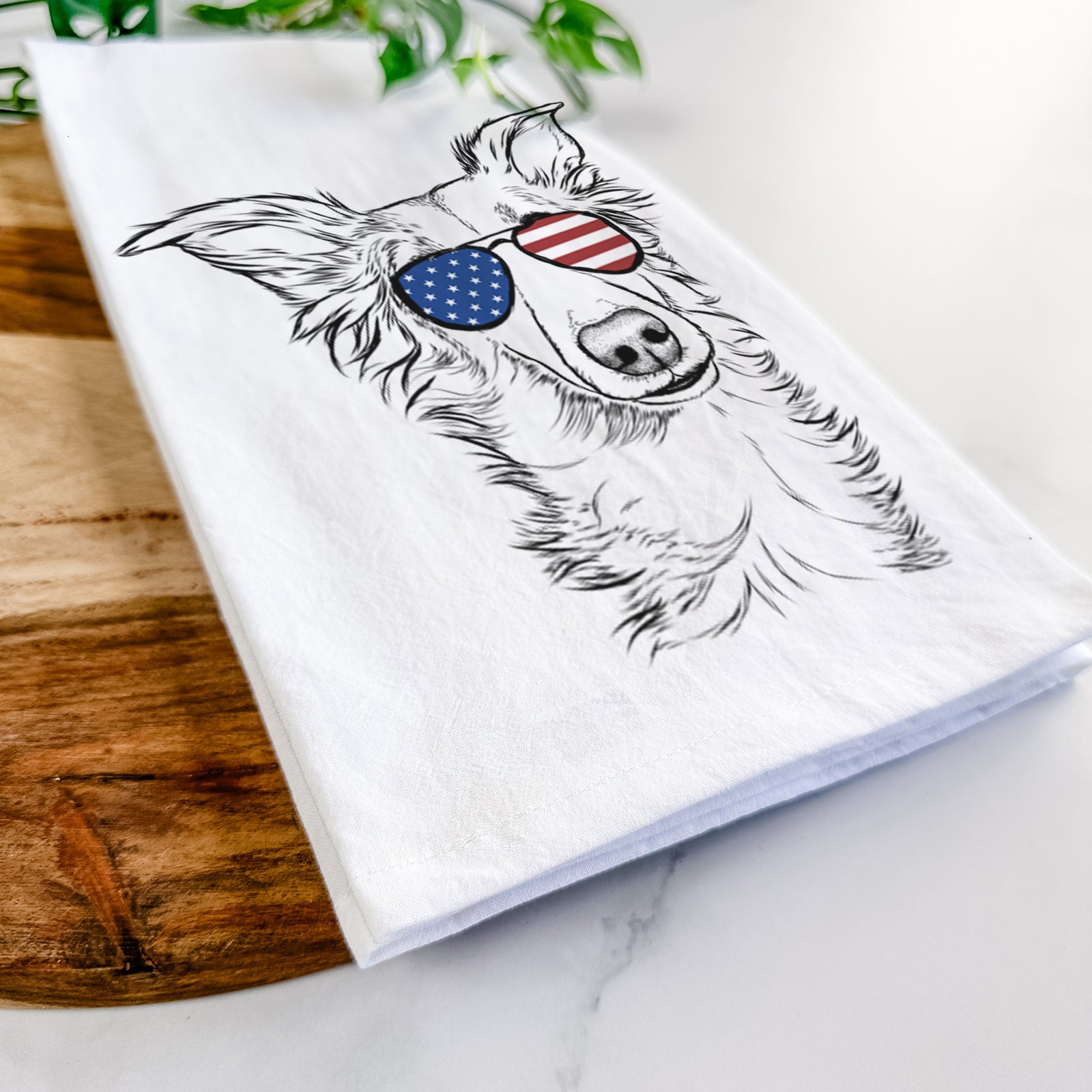 Hand-drawn sketch of Kyu the Windsprite wearing American flag sunglasses on a tea towel