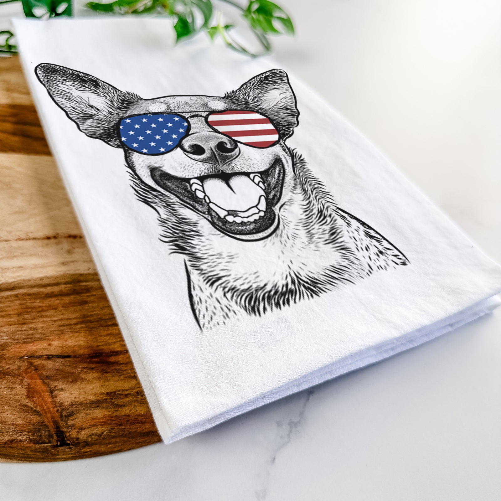 Hand-drawn sketch of Lily the Australian Cattle Dog wearing American flag sunglasses on a tea towel