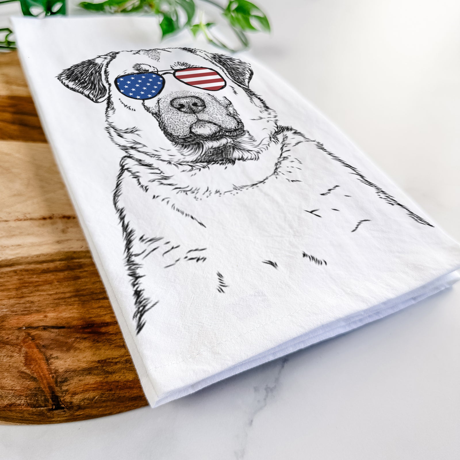 Hand-drawn sketch of Loca the Anatolian Shepherd wearing American flag sunglasses on a tea towel