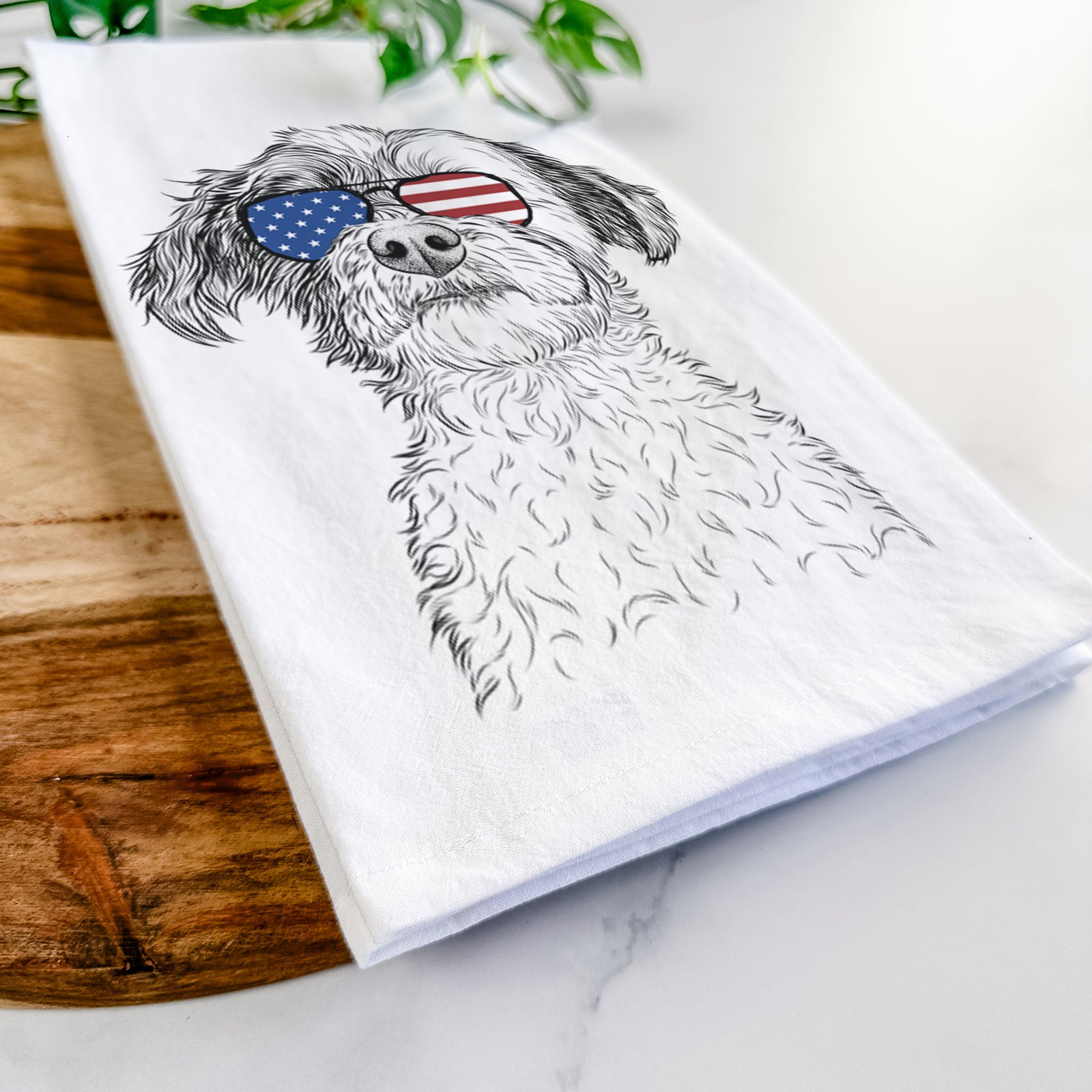 Hand-drawn sketch of Louise the Havanese wearing American flag sunglasses on a tea towel