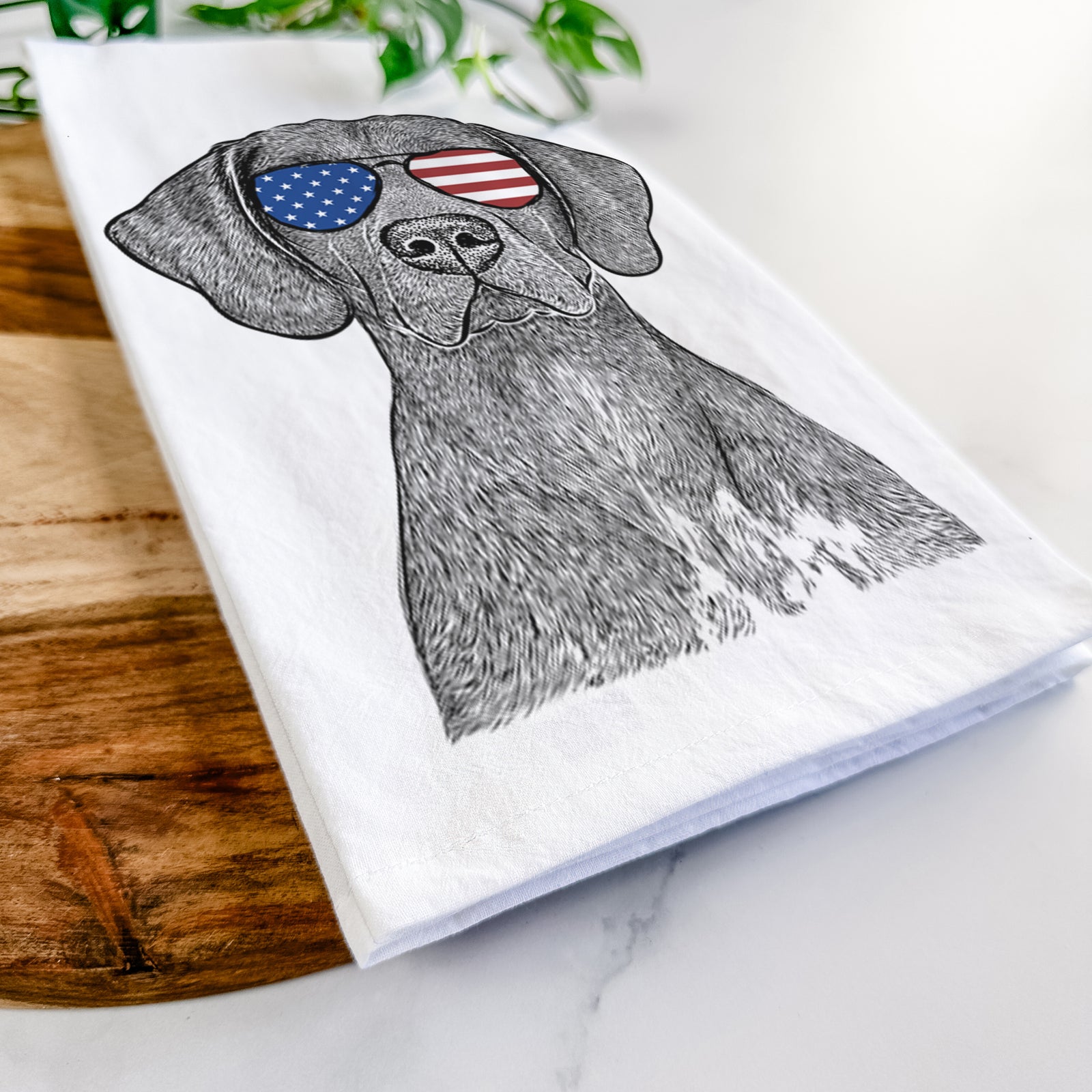 Hand-drawn sketch of Lucifer the German Shorthaired Pointer wearing American flag sunglasses on a tea towel