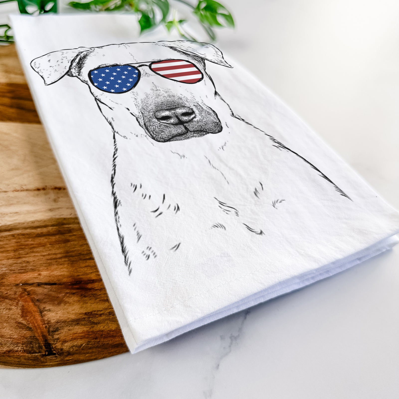 Hand-drawn sketch of Luna the Black Mouth Cur wearing American flag sunglasses on a tea towel