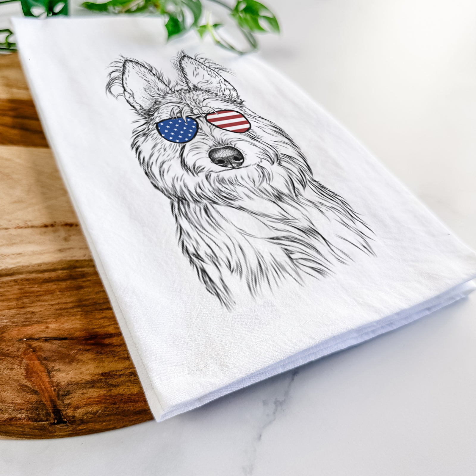 Hand-drawn sketch of Luna the Berger Picard wearing American flag sunglasses on a tea towel