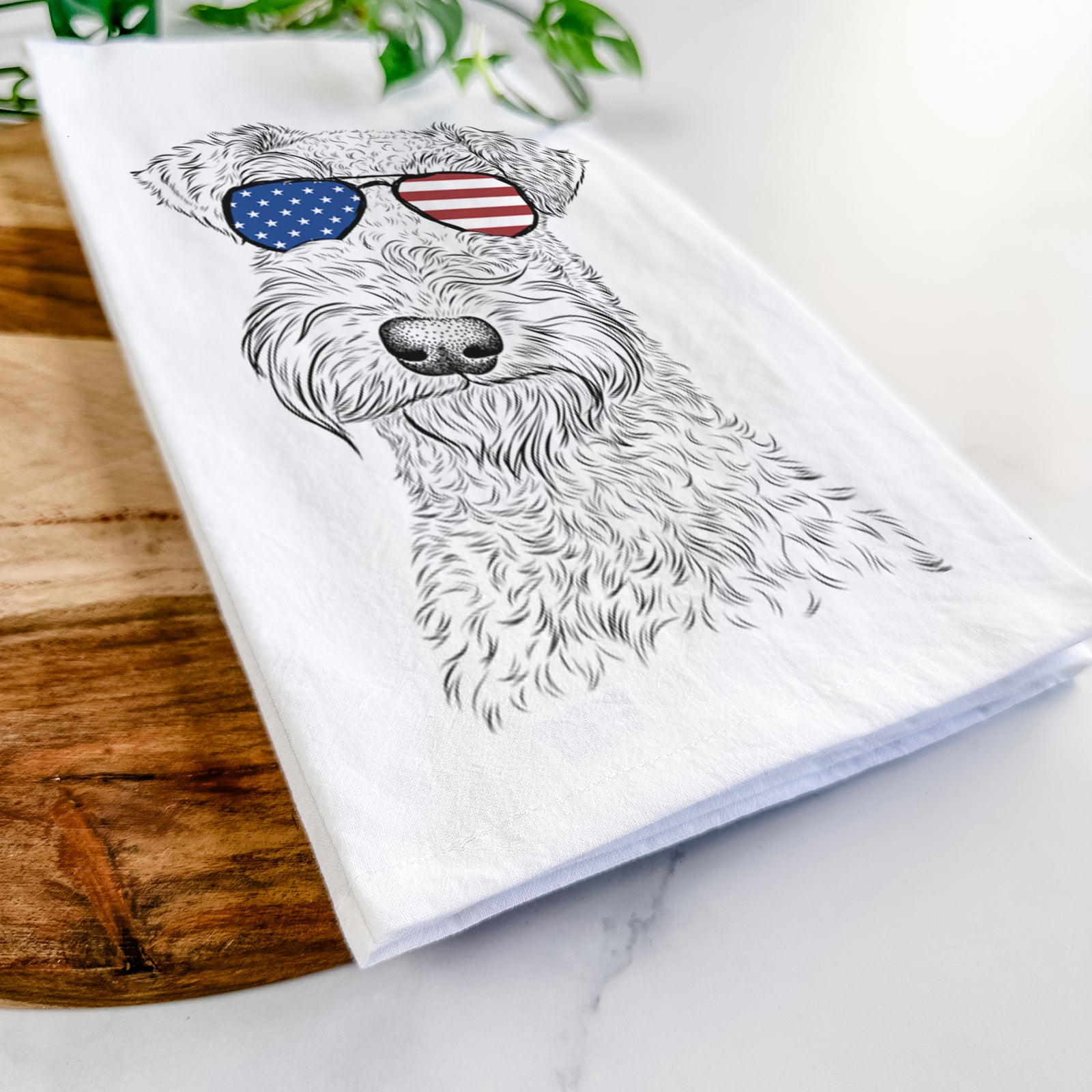 Hand-drawn sketch of Roc Haven Maggie May the Airedale Terrier wearing American flag sunglasses on a tea towel