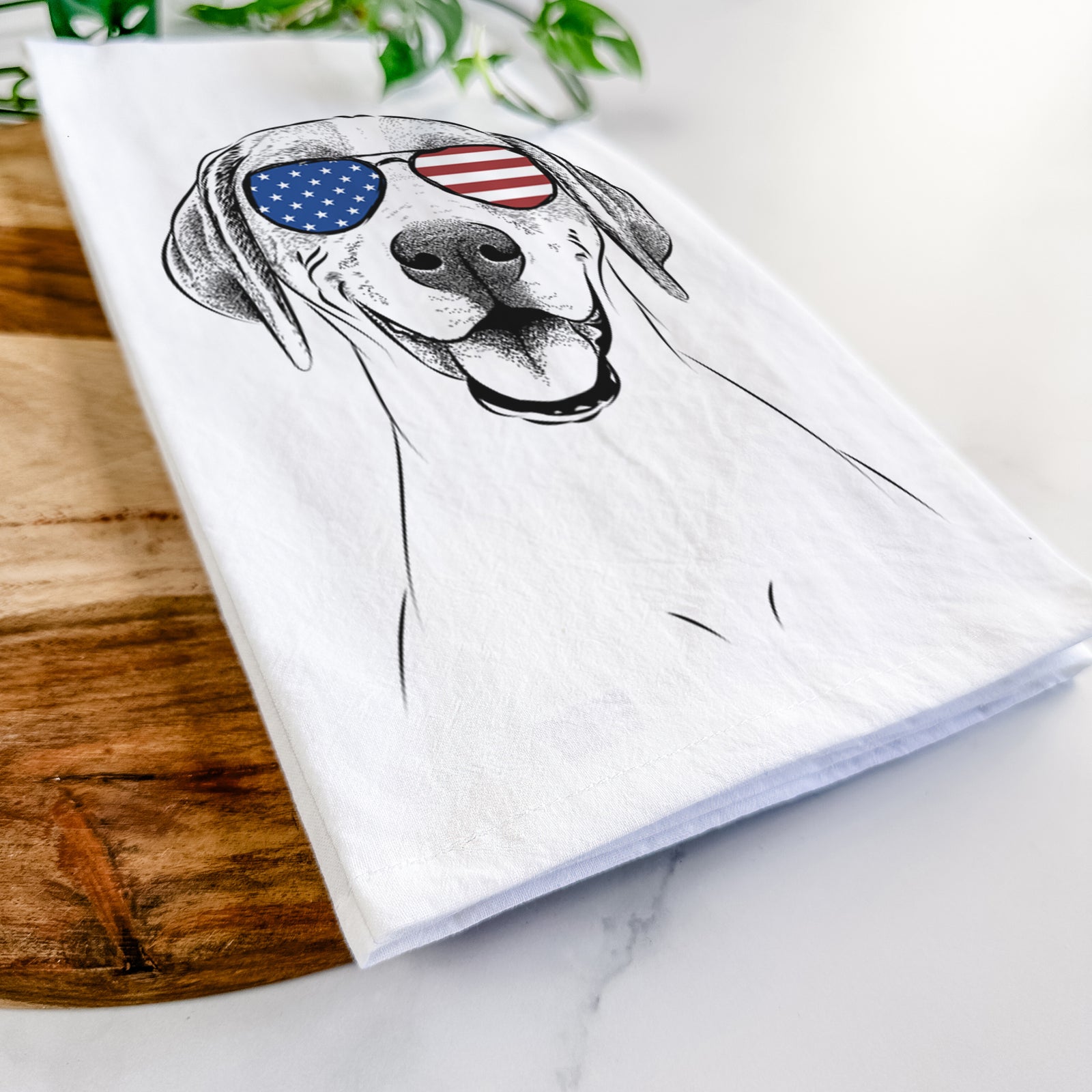 Hand-drawn sketch of Maggie the Treeing Walker Coonhound wearing American flag sunglasses on a tea towel