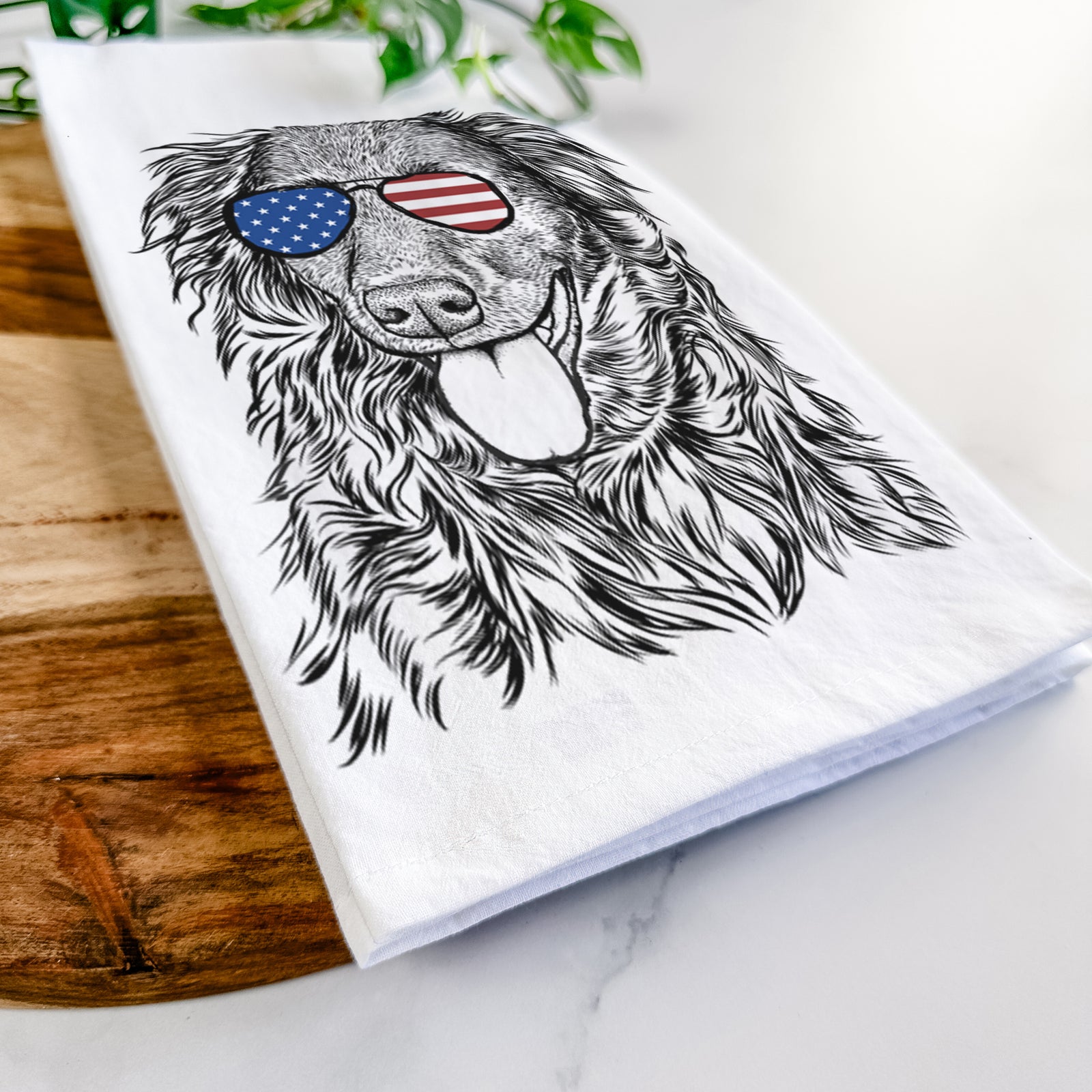 Hand-drawn sketch of Maisie Mae the Aussiedor wearing American flag sunglasses on a tea towel