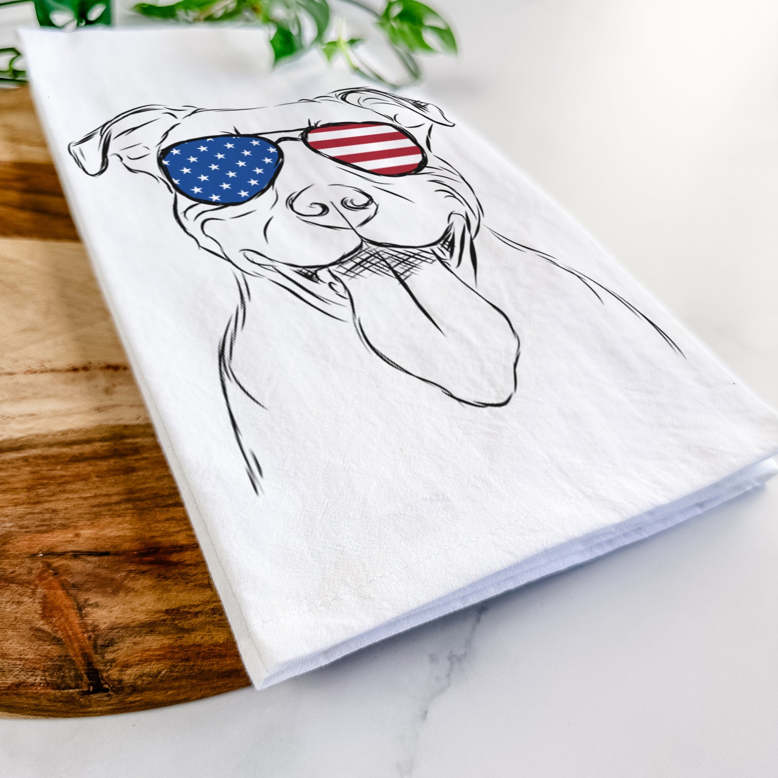 Hand-drawn sketch of Major the Pitbull wearing American flag sunglasses on a tea towel