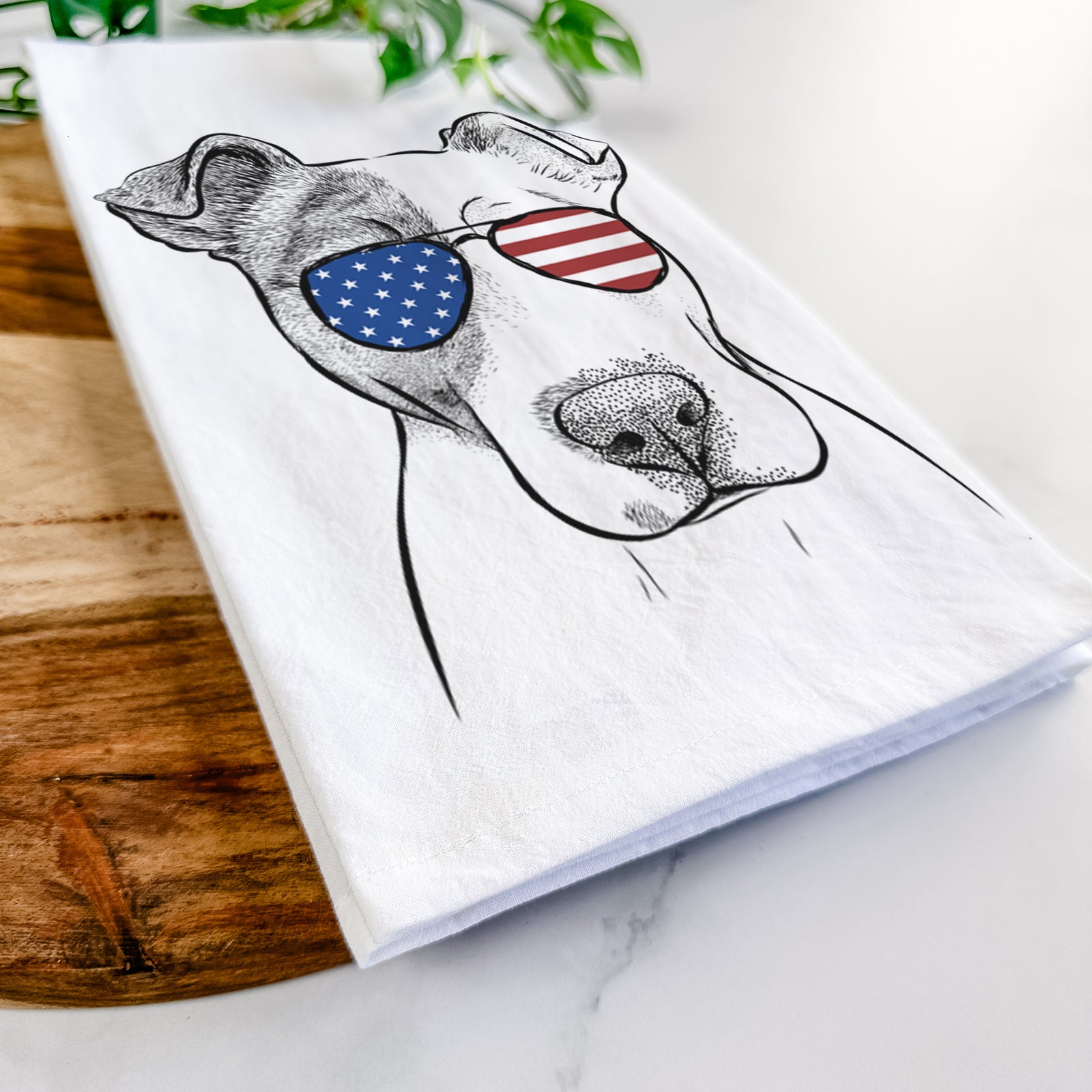 Hand-drawn sketch of Manchi the Pitbull Mix wearing American flag sunglasses on a tea towel
