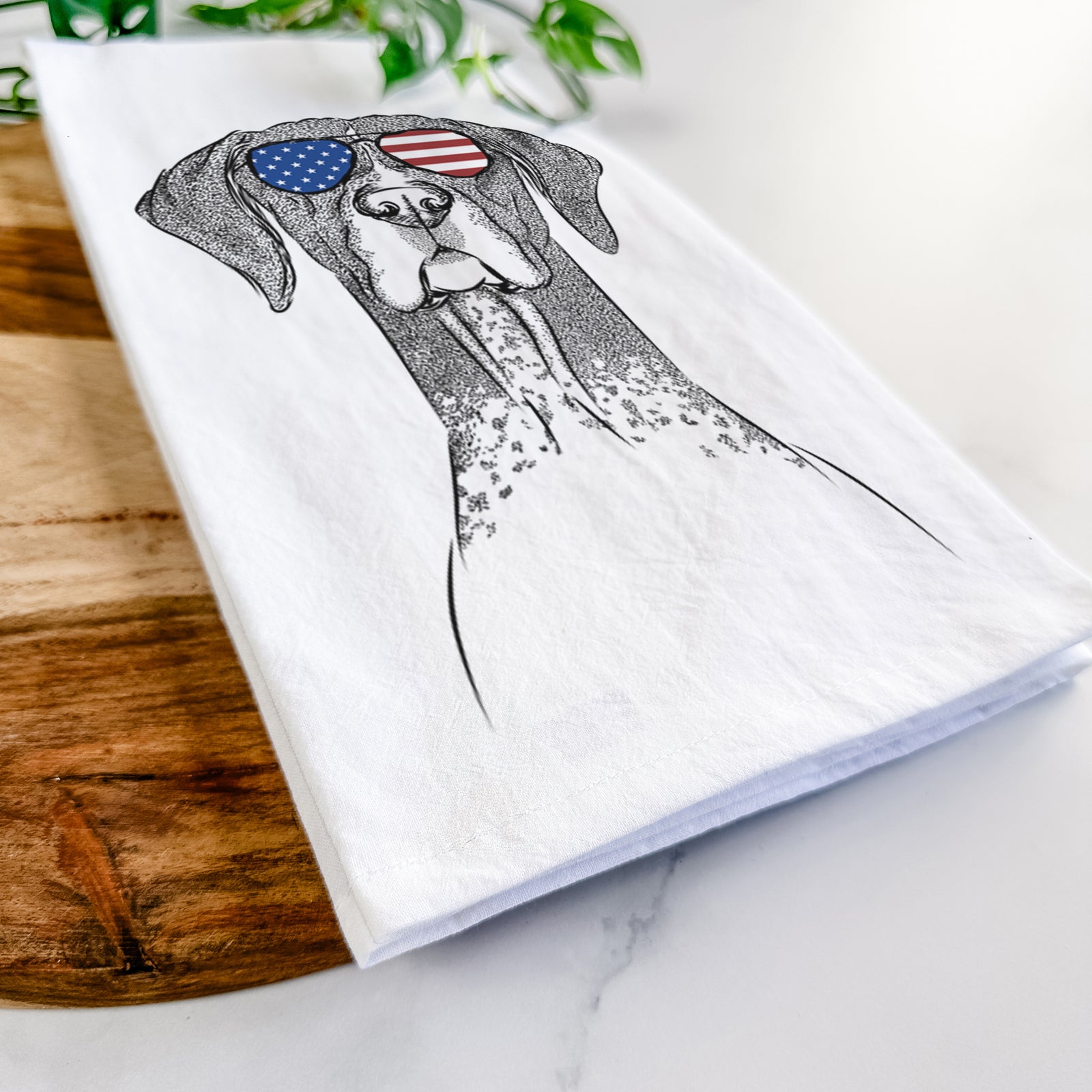 Hand-drawn sketch of Mattis the German Shorthaired Pointer wearing American flag sunglasses on a tea towel