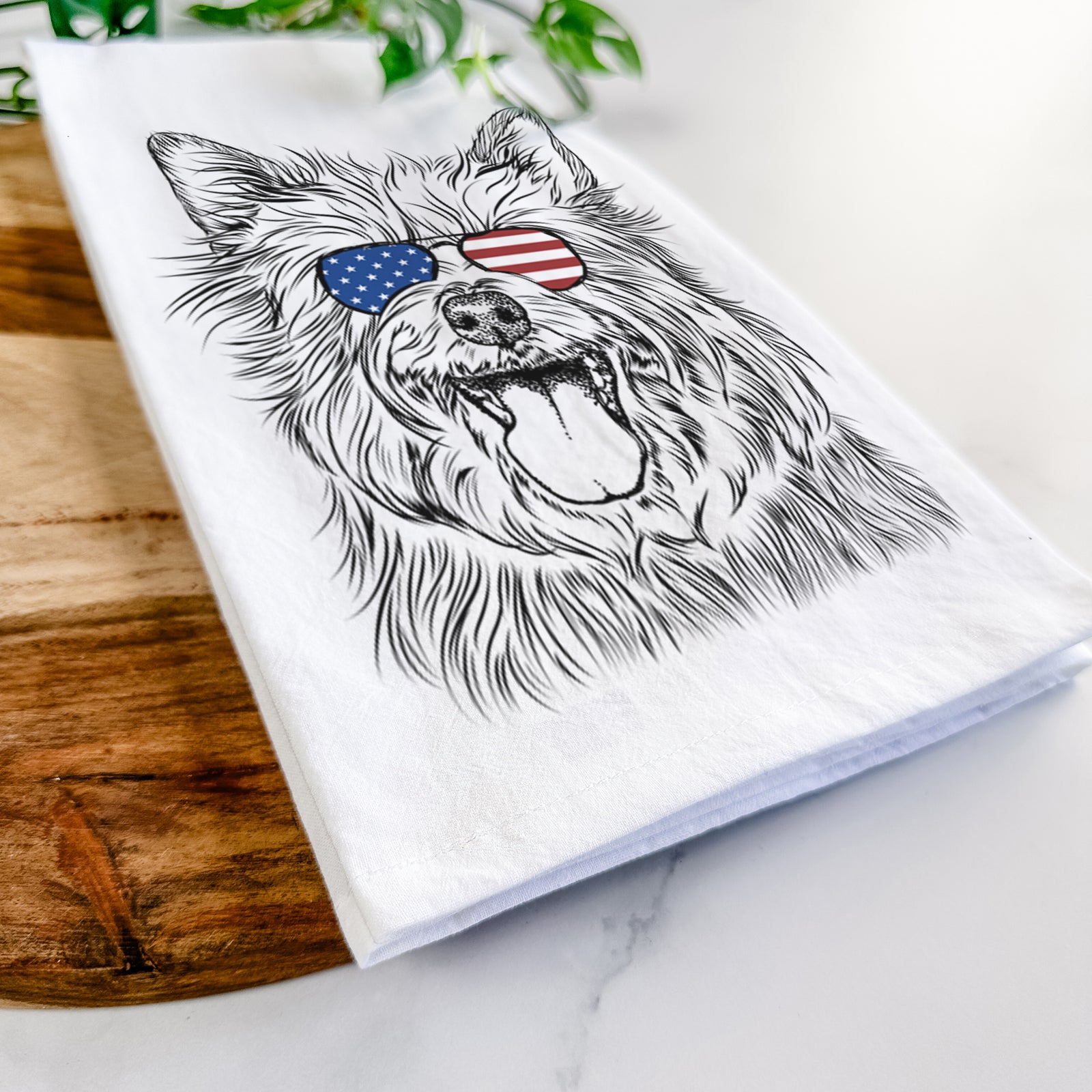 Hand-drawn sketch of Middy the Australian Terrier wearing American flag sunglasses on a tea towel