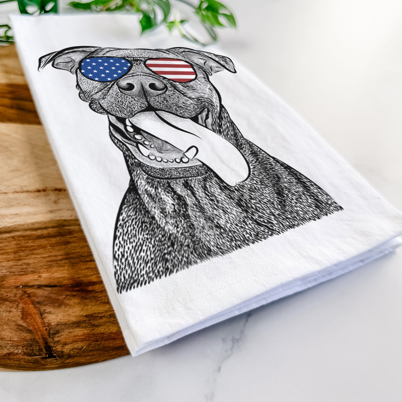 Hand-drawn sketch of Mikey the Boxador wearing American flag sunglasses on a tea towel